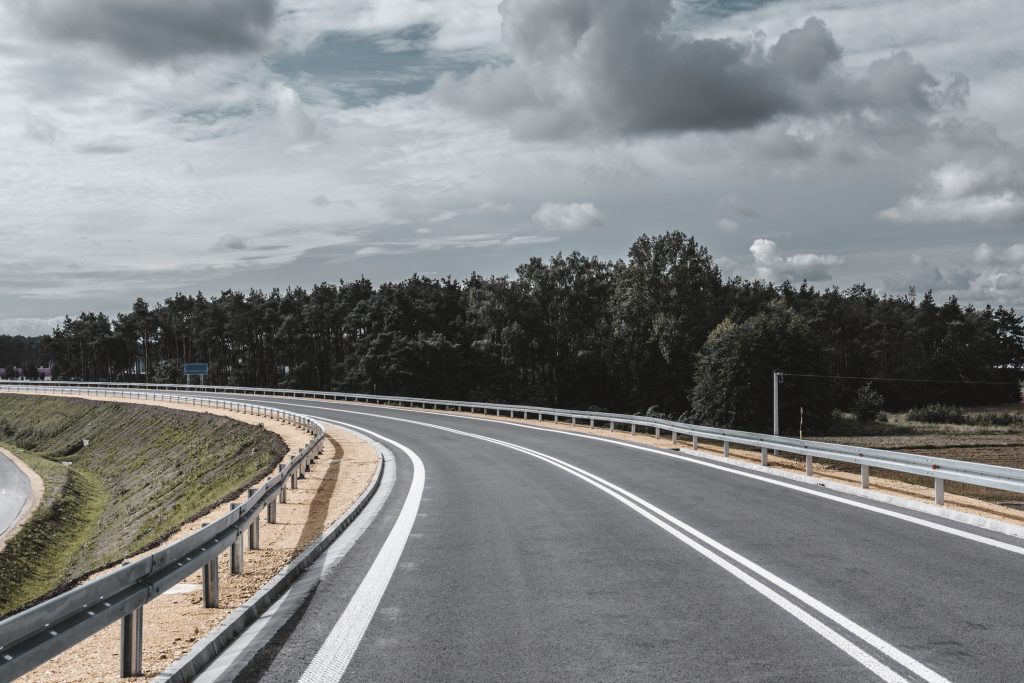 A road bend with a guard rail.