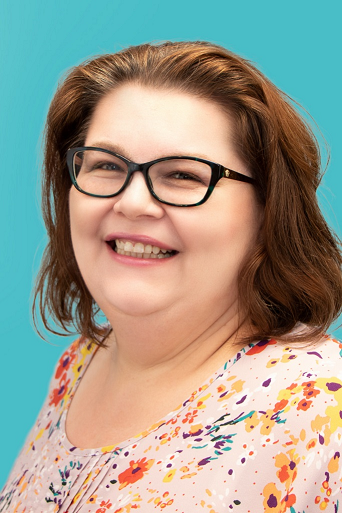 JJ Cloutier, smiling white heavy set woman with shoulder length brown hair and glasses