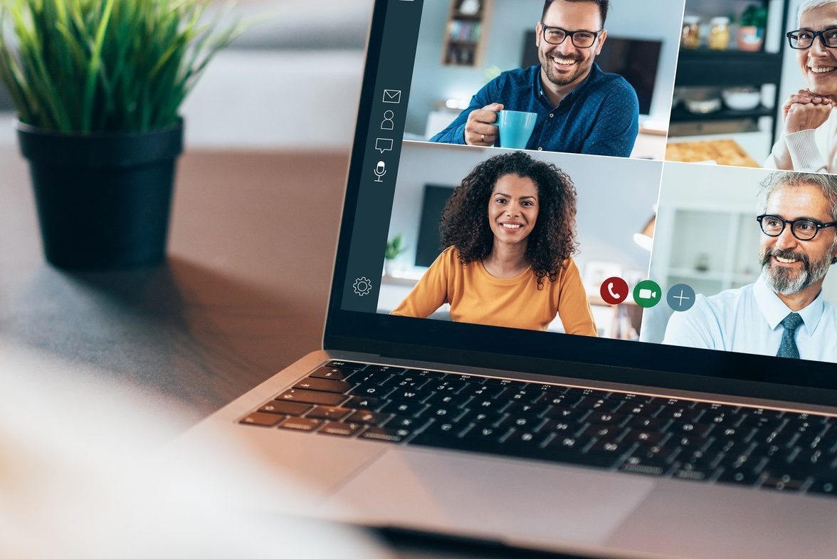 Over the shoulder shot of person using a laptop with video conference app